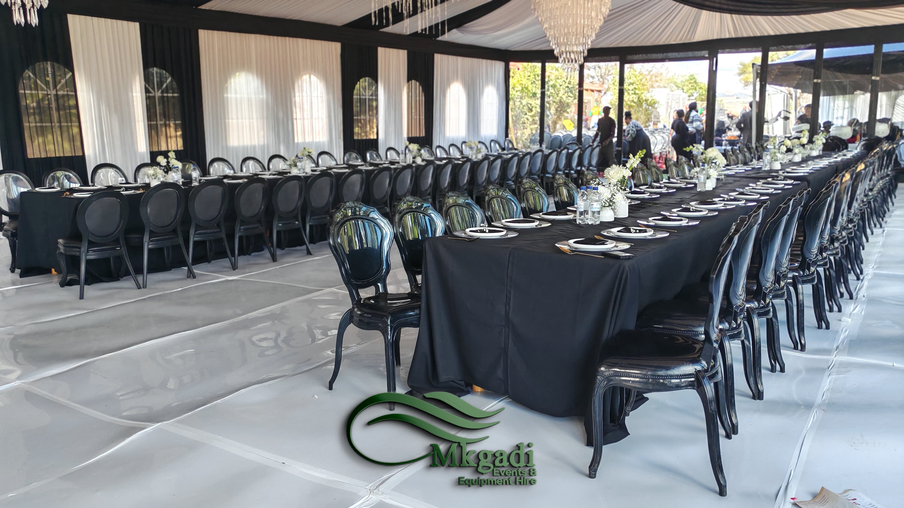 Close-up of intricate fabric draping with sheer white and green layers creating a luxurious backdrop for a formal event